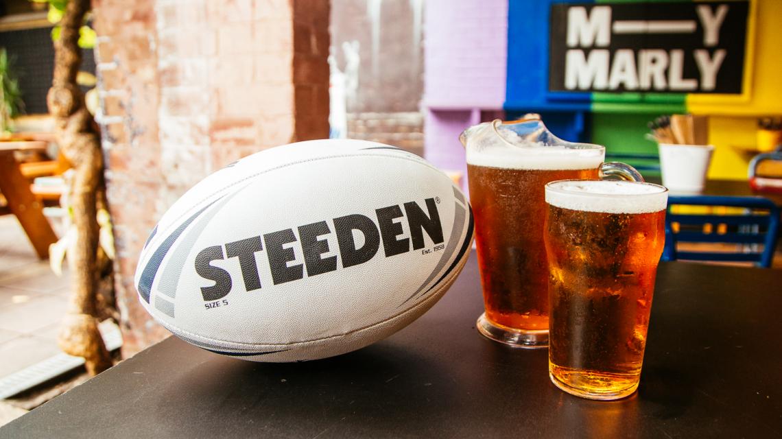 A football next to a jug & pint of beer in the Beer Garden